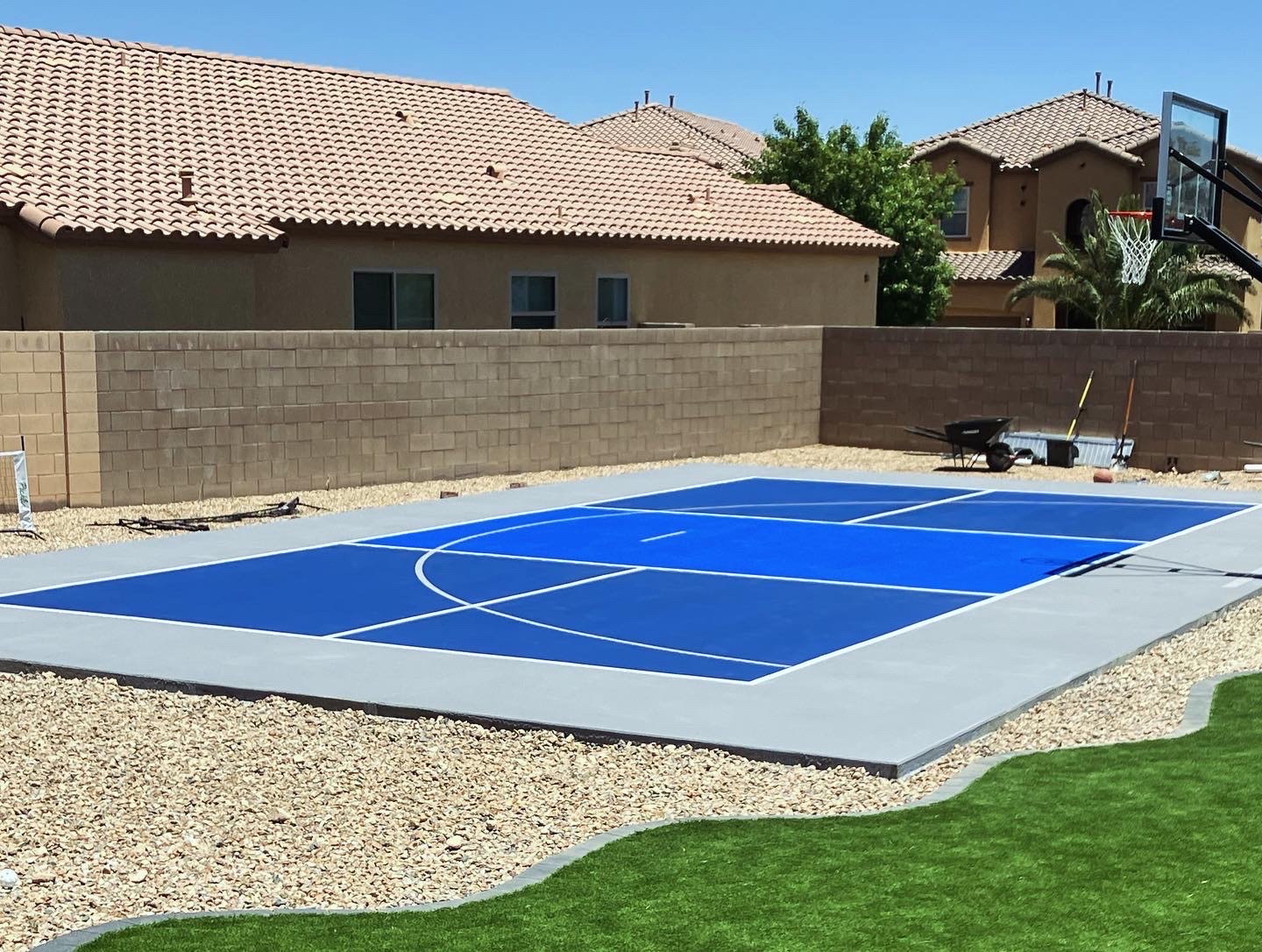 Backyard pickleball court with blue and grey playing surface in Southern Nevada